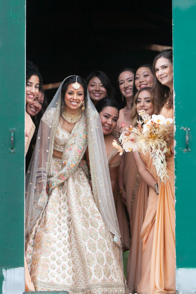 A group of women in wedding dresses posing for the camera.