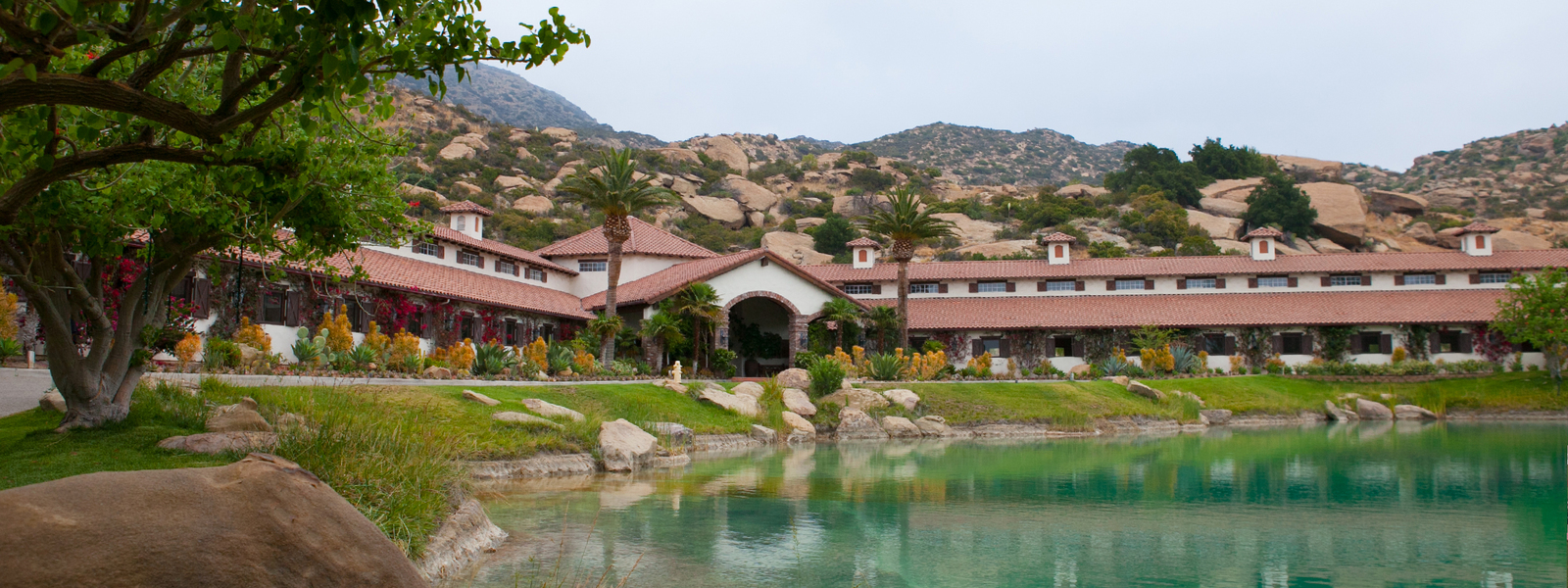 A large building with a pond in front of it