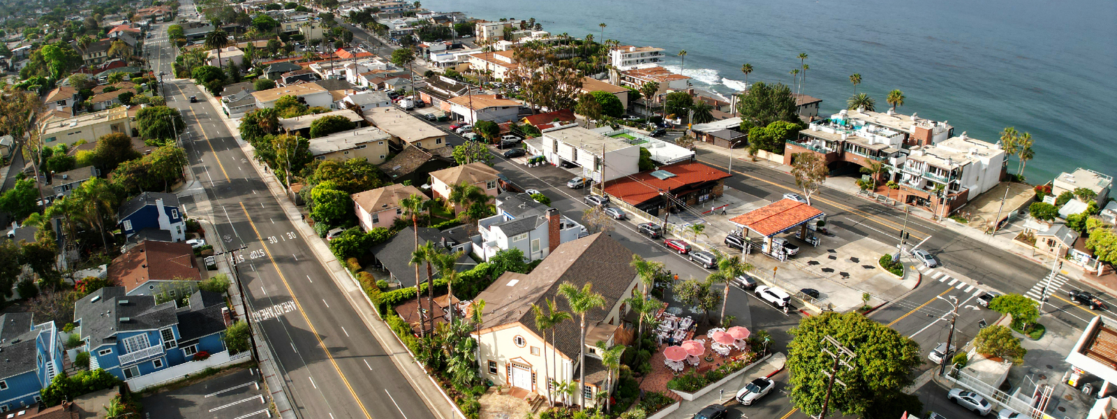 A view of houses and the ocean from above.